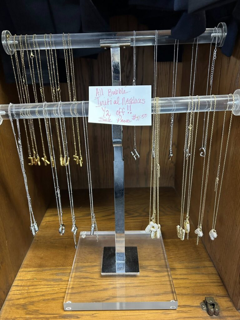 Assorted initial necklaces on display.
