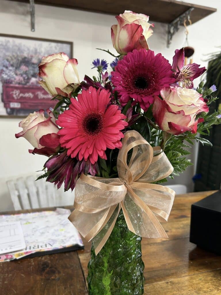 A pink gerbera and rose flower bouquet.