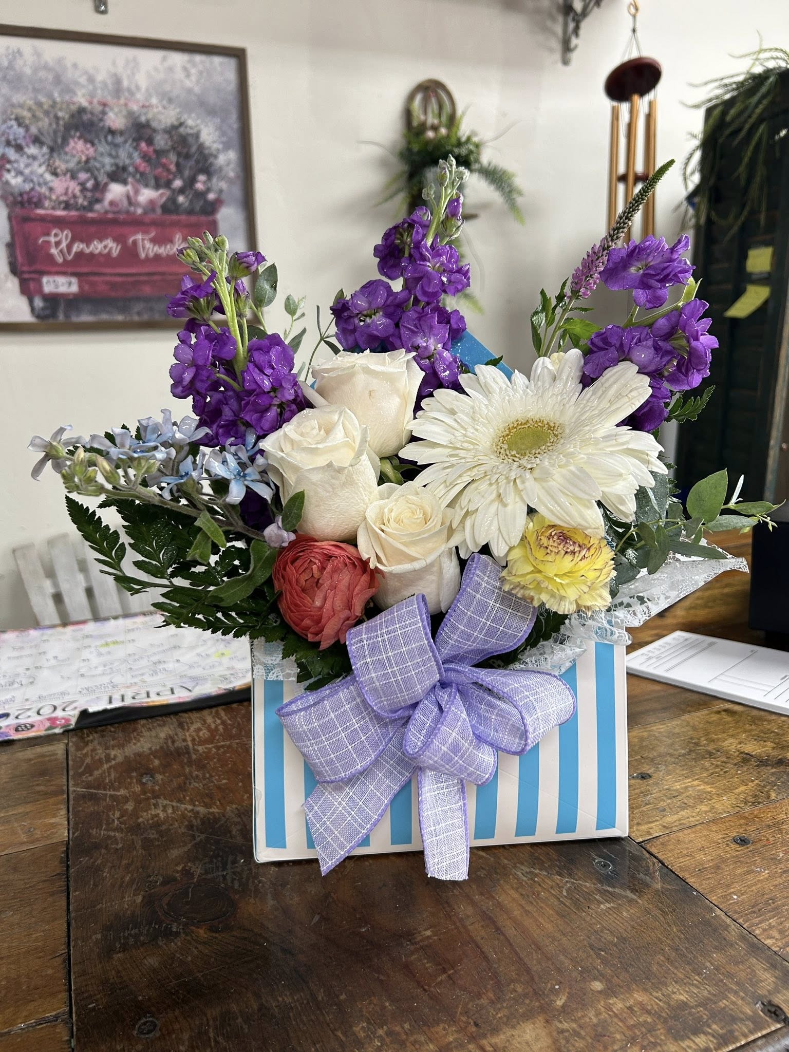 A striped box flower arrangement.